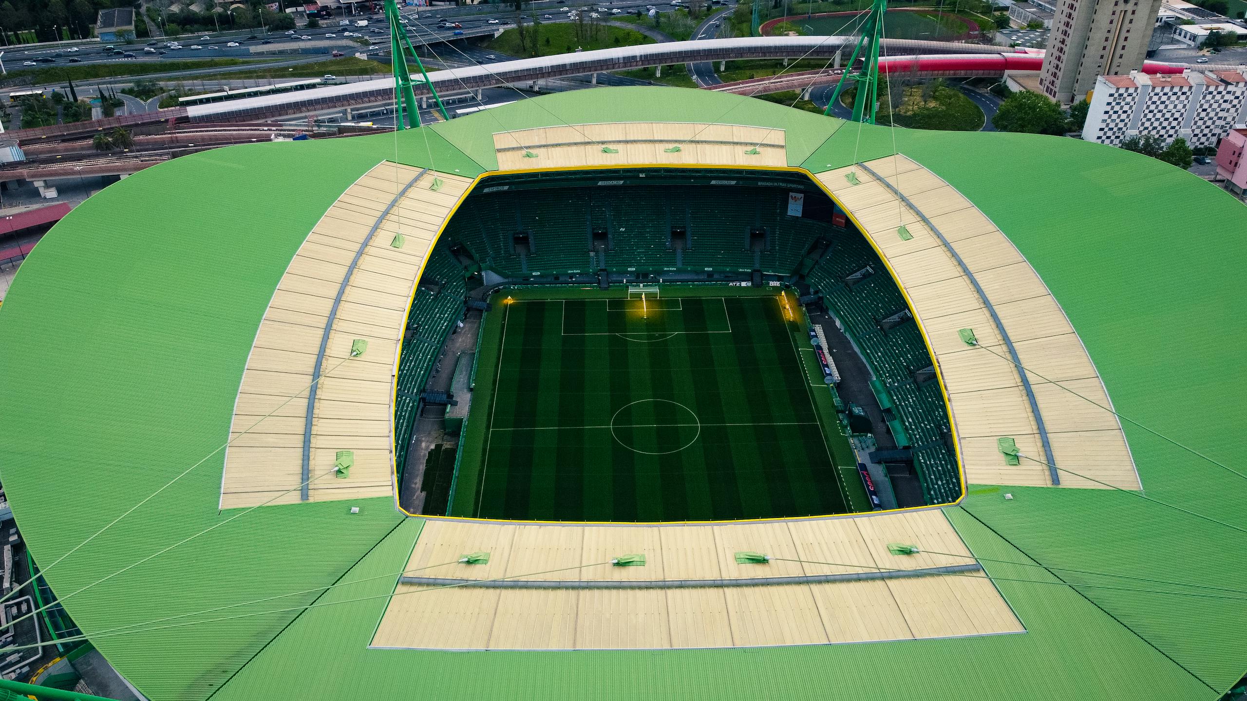 A stunning aerial shot of Estádio José Alvalade in Lisbon, showcasing its unique architecture and lush field.