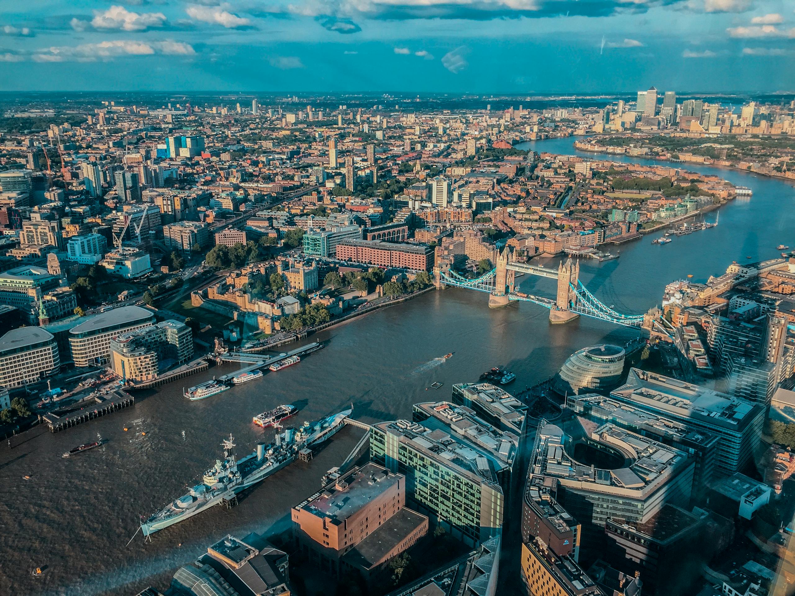 Stunning aerial view over London featuring the iconic Tower Bridge and River Thames.
