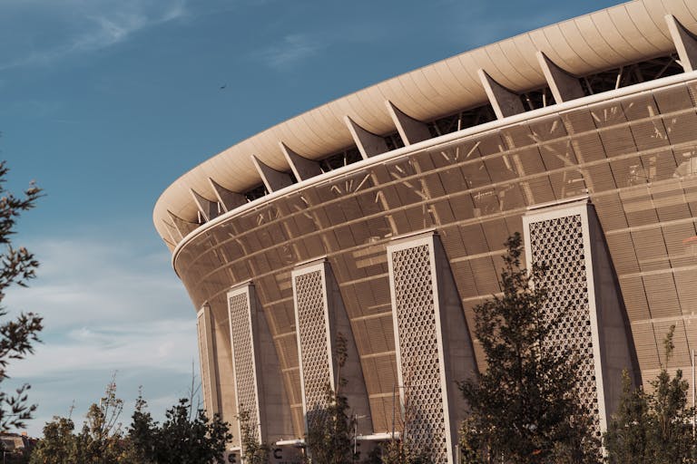 A close-up of Ferenc Puskás Stadium's architecture in Budapest, captured on a sunny day.
